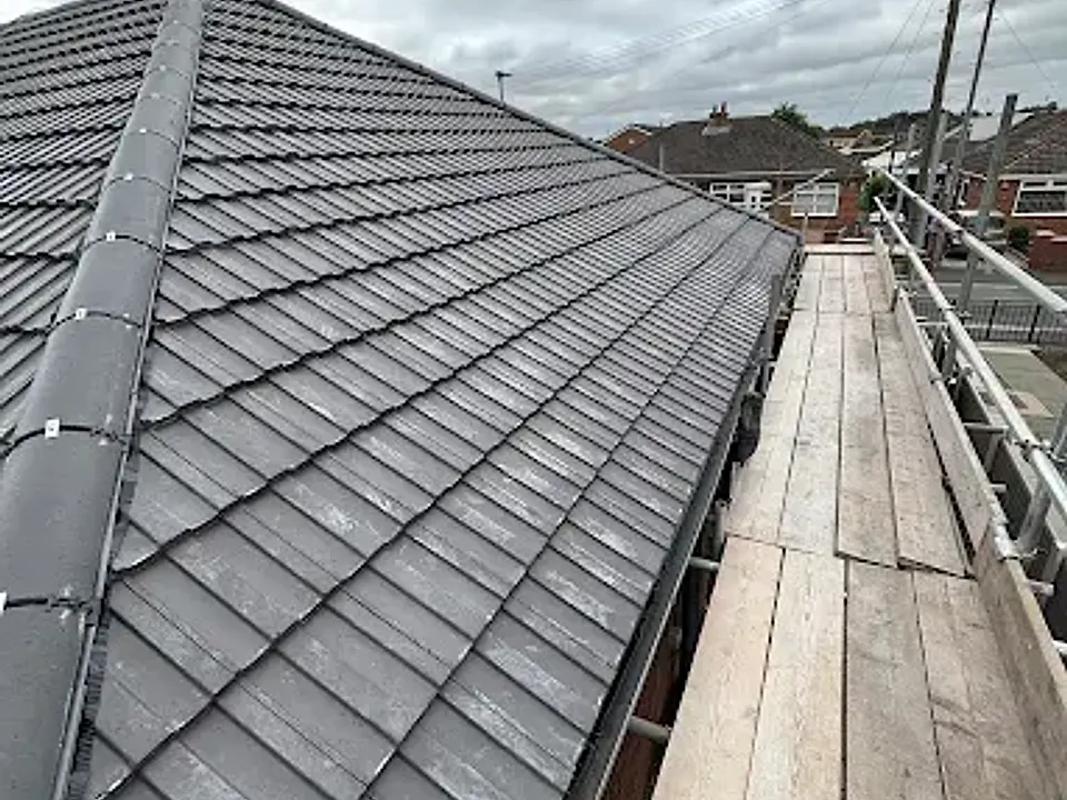 Long run of new roof tiles along scaffolding