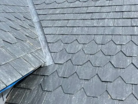 Ornamental fishscale slate detail on a pitched roof