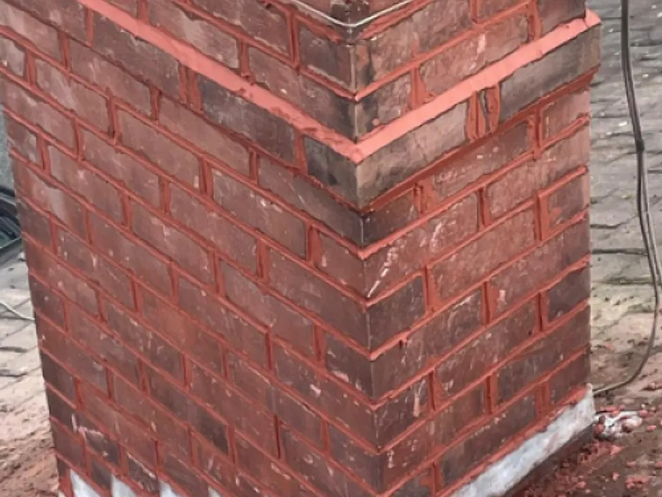 Rebuilt brick chimney stack with fresh mortar joints