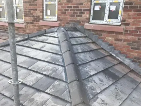 New slate hip roof on a brick house