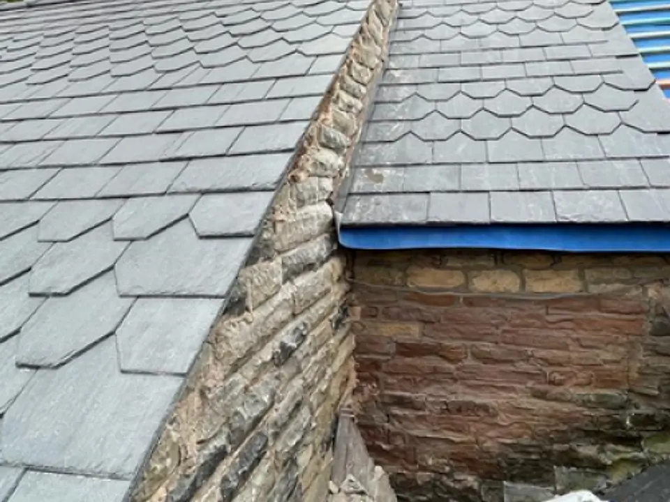 Slate roof meeting a stone gable