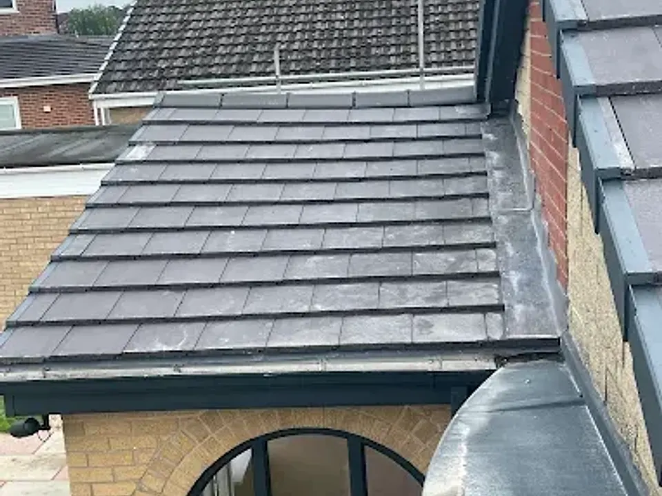 Slate-effect tiles with lead dormer detail