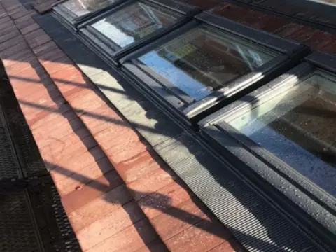 Three Velux roof windows fitted in a slate roof