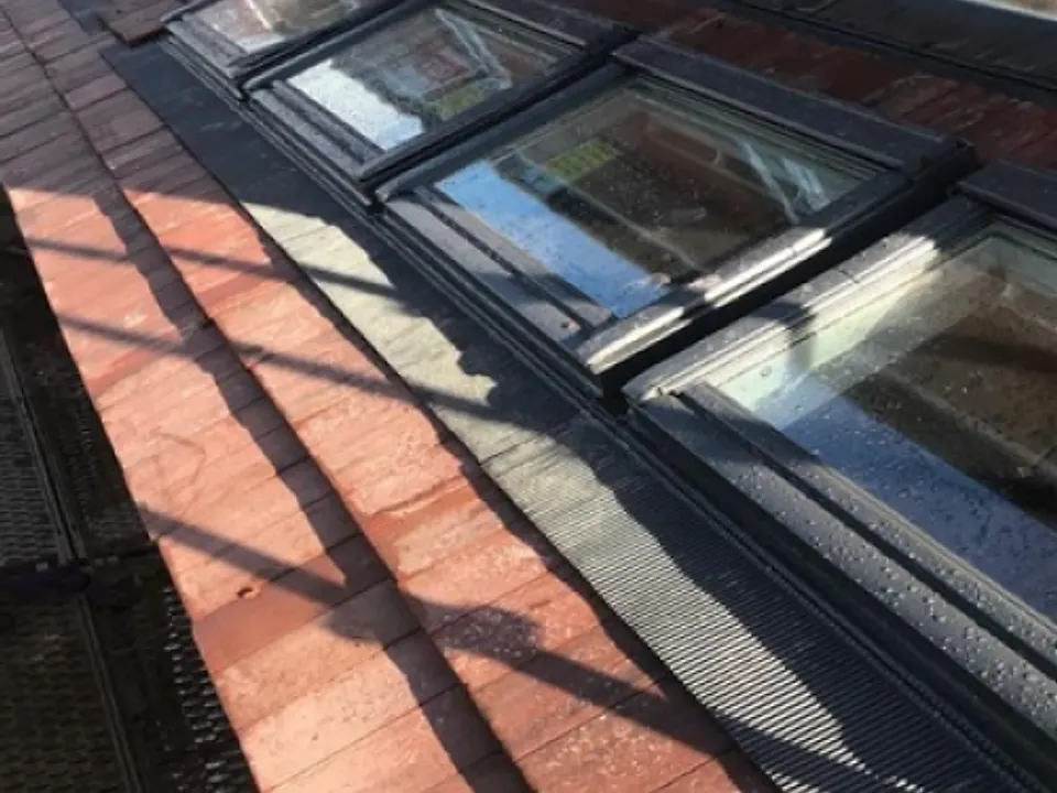 Three Velux roof windows fitted in a slate roof